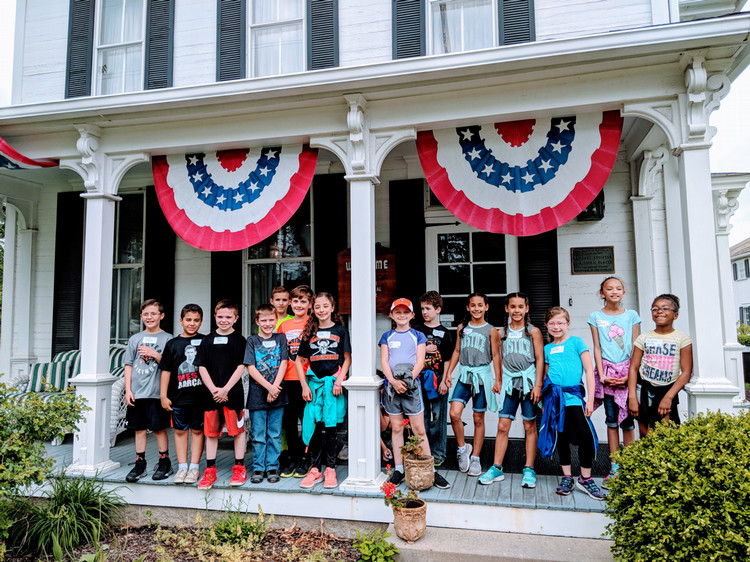 Group of students on the front porch of the Hoover Historical Center