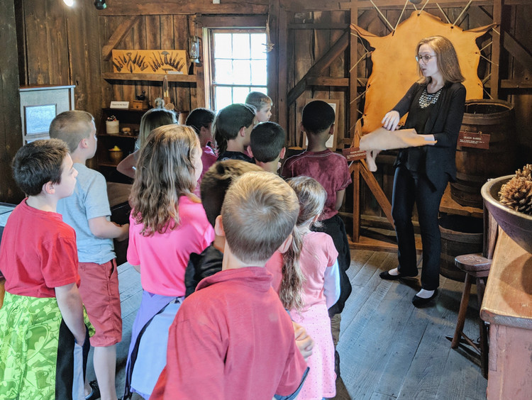 A group of students attending a tour in the tannery